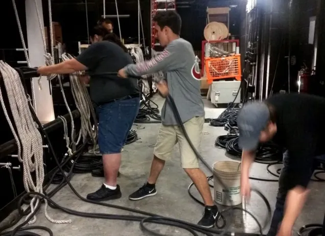 backstage people pulling a rope