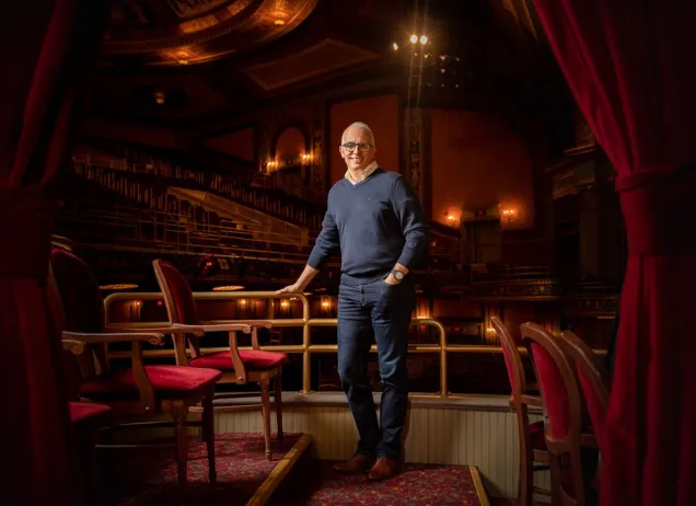 man standing in the theater posing