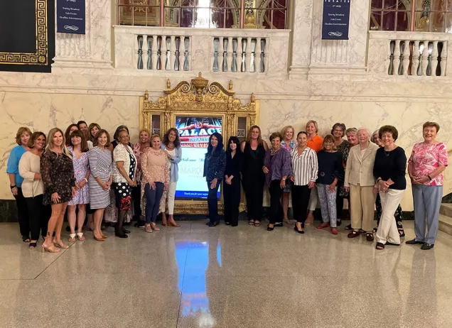 Group of women standing in a marble room