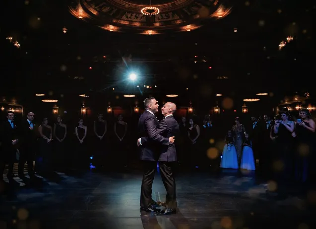 Married couple dancing on the stage during a wedding