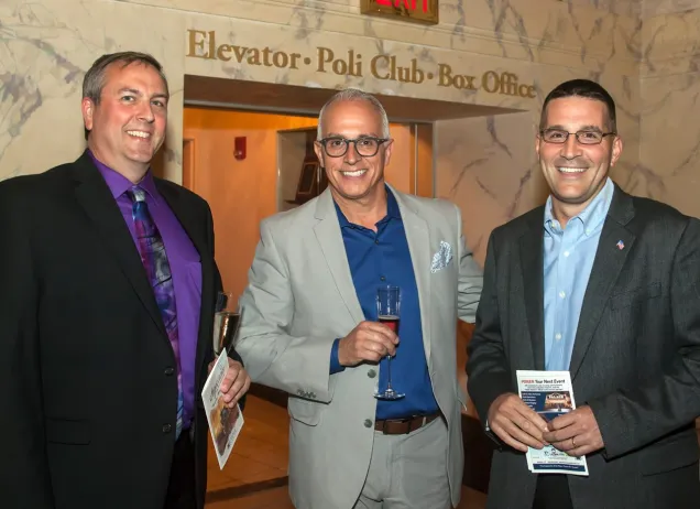 3 men in front of elevator